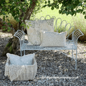 upthegardencompany.co.uk Isabelle sky blue finish garden bench with looped pattern back. Dressed with chic cushions.
